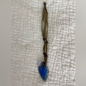 Cute necklace never used with iridescent blue pendant.